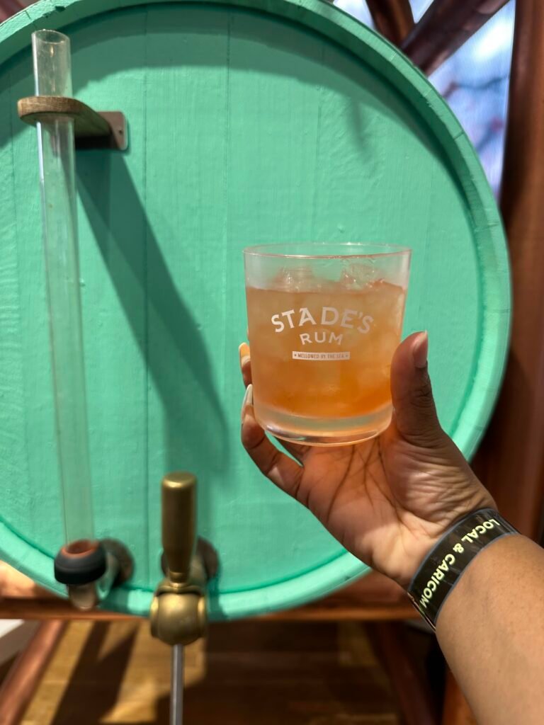 me holdig a glass of rum punch at Stades Rum